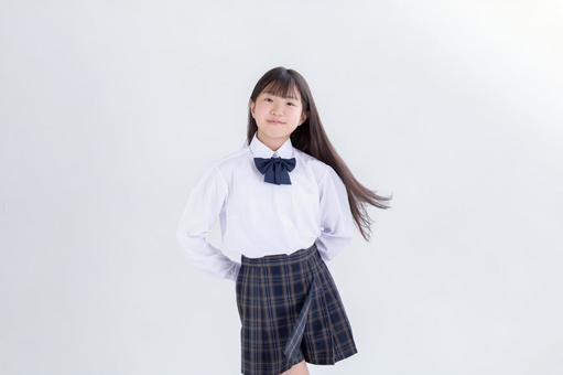 制服を着たロングヘアの小学生 制服,白背景,カメラ目線の写真素材
