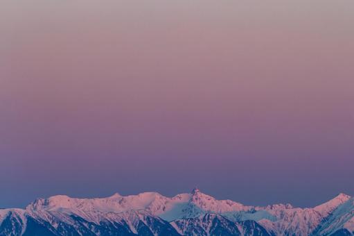 ピンクの朝焼けとアルプス連峰 冬,雪山,アルプスの写真素材