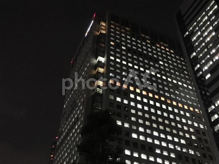 明かりが点いている夜の高層オフィスビル ビル,夜景,高層ビルの写真素材