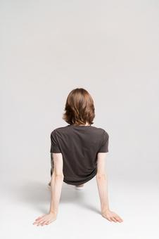 A man in a pose with both hands and feet on the floor, male, rear view, pause, JPG