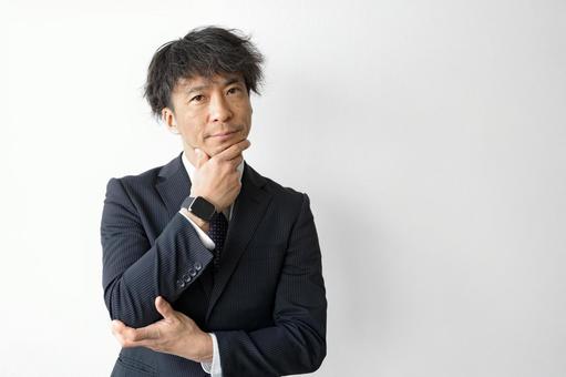 A man in a suit putting his hand on his chin (Part 122), business, male, real estate, JPG