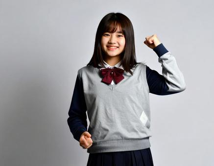 ガッツポーズをする女子生徒のイメージ ガッツポーズをする女子生徒のイメージの写真