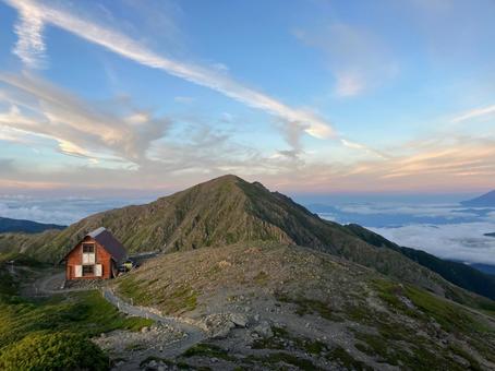 夕暮れの中岳避難小屋と悪沢岳 夕暮れの中岳避難小屋と悪沢岳 夕日,夕焼け,日没の写真素材