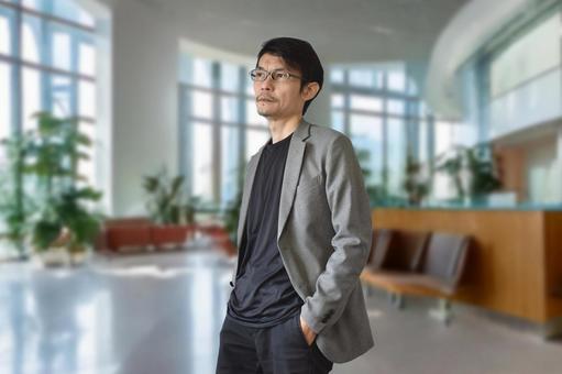 ジャケットを着たメガネの男性 男性,メガネ,ホテルの写真素材