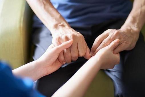 Hands of caregivers and the elderly Hands of caregivers and the elderly