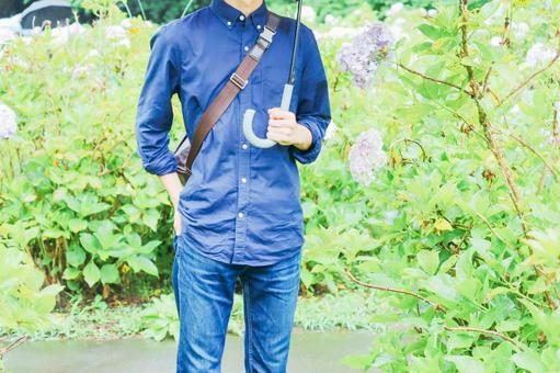 Man with hydrangea and umbrella Man with hydrangea and umbrella