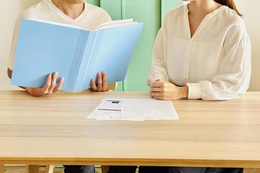書類を見て相談する男女 書類を見て相談する男女 書類,資料,仕事の写真素材