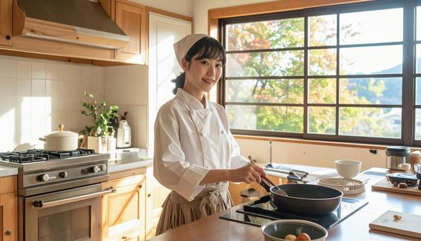 レストランの調理場で料理するスタッフ女性の写真