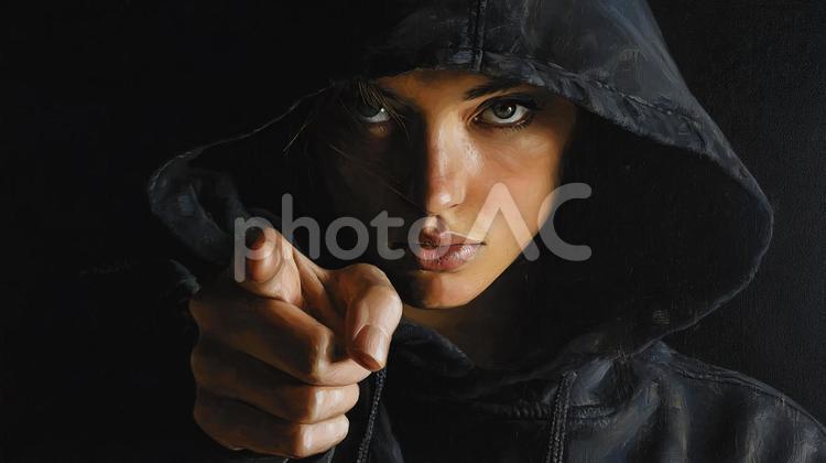 反骨精神を秘めた女性の表情 女性,フード,中指の写真素材
