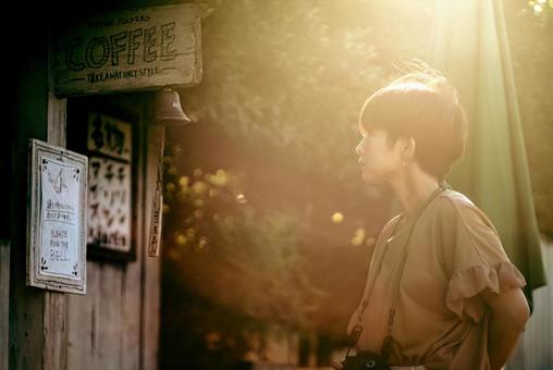 <Material> A woman strolling around a tourist spot at dusk, JPG