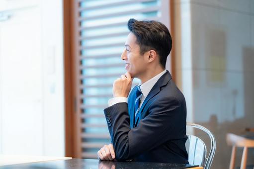 スーツの男性 笑顔,会話,打ち合わせの写真素材