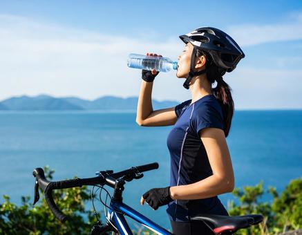 サイクリストの夏・休憩と給水(背景に海) サイクリストの夏・休憩と給水(背景に海)の写真