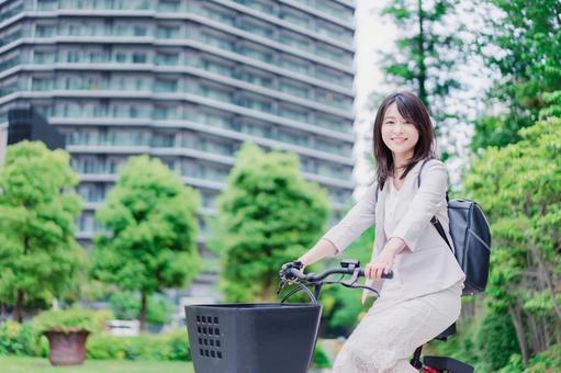 Photo, career woman, electric assisted bicycle, park, 