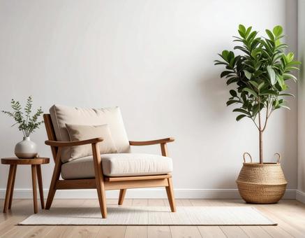 木製アームチェアと観葉植物の室内の写真