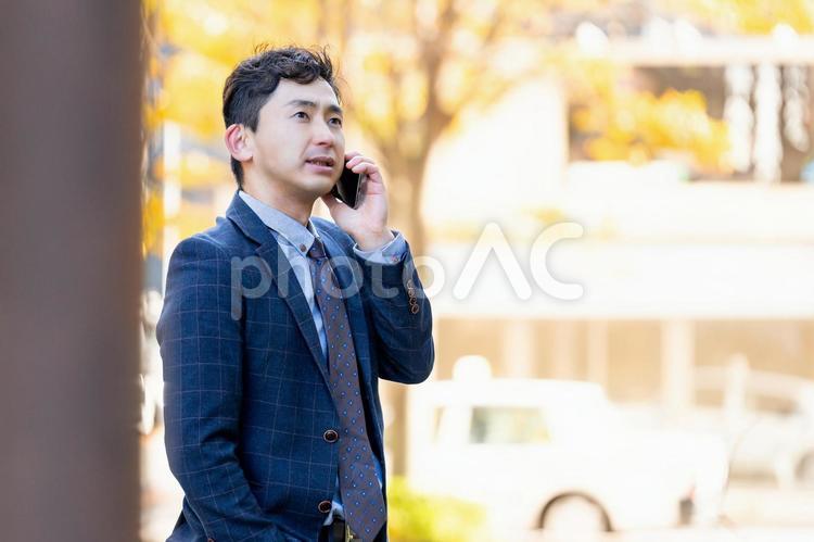 街角でスマホで話す男性ビジネスマン 男性,ビジネス,ビジネスマンの写真素材
