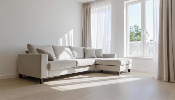 白いソファだけが置かれたシンプルリビングの写真