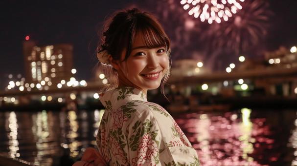 打ち上げ花火を背景に笑顔の浴衣女性 打ち上げ花火を背景に笑顔の浴衣女性の写真