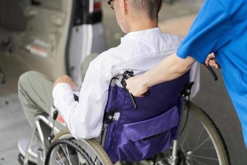 A caregiver who puts an elderly person in a long-term care taxi A caregiver who puts an elderly person in a long-term care taxi