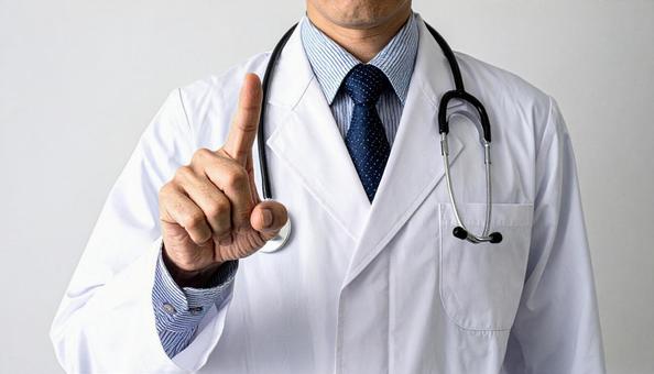 注意! 人差し指を立てる白衣を着た男性 注意! 人差し指を立てる白衣を着た男性の写真