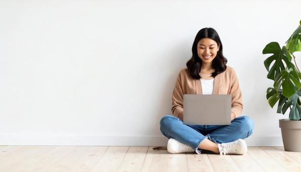 A woman sitting cross-legged and looking at a computer screen, laptop, cuff, female, JPG