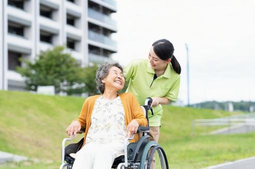 車椅子のシニアの女性と介護福祉士 車椅子のシニアの女性と介護福祉士 介護,シニア,女性の写真素材