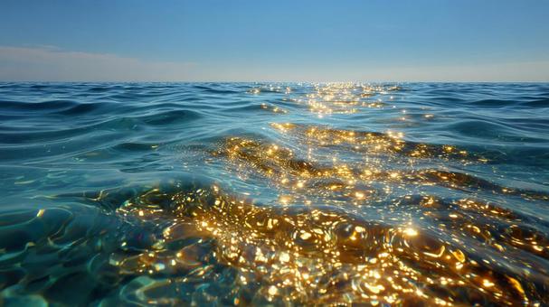 金色に輝く水面と穏やかな青い海 金色に輝く水面と穏やかな青い海の写真