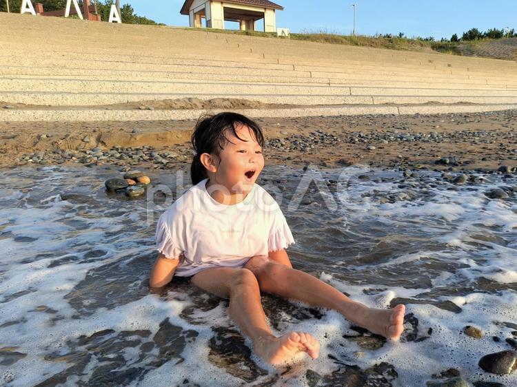 迫りくる波に雄たけびを上げる女の子2 水遊び,雄たけび,海水浴の写真素材