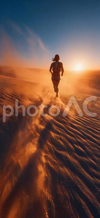 夕焼けの砂漠を走る決意に満ちたランナー 砂漠,ランナー,男性の写真素材