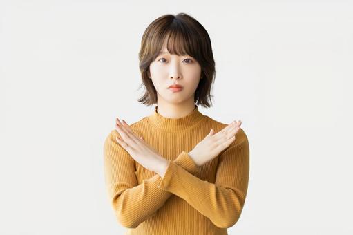 手でバツのポーズをする困った表情の女性 手でバツのポーズをする困った表情の女性 女性,バツ,だめの写真素材