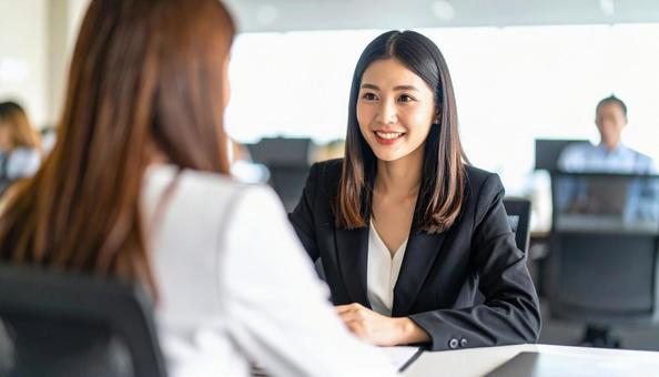 商談風景　顧客に提案する女性会社員の写真