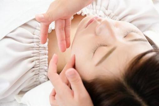 Hands of females and practitioners receiving face massage Hands of females and practitioners receiving face massage