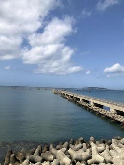 Ocean landscape with blue sky and pier, JPG