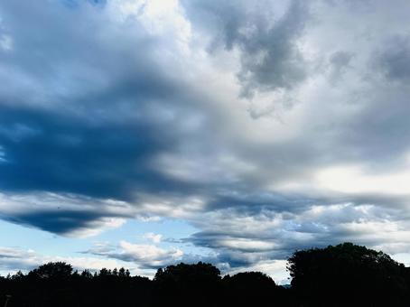 Mountain silhouettes and fluffy clouds stretching into the distance, JPG