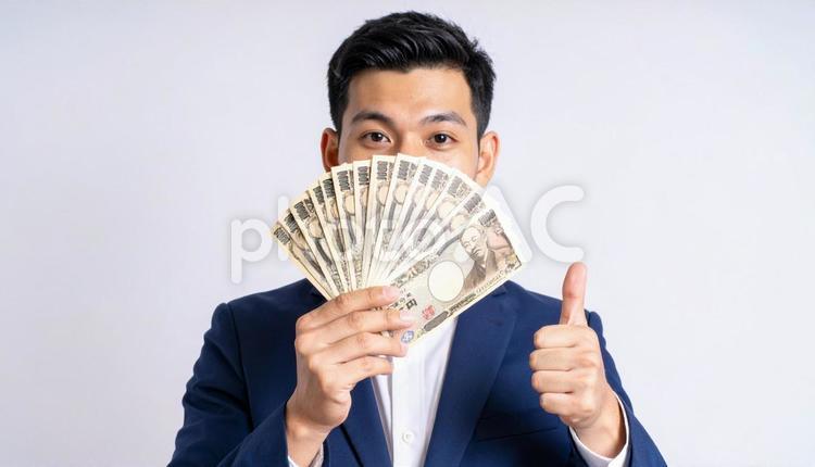 大金を手にして親指を立てるビジネスマン 手,指,札の写真素材