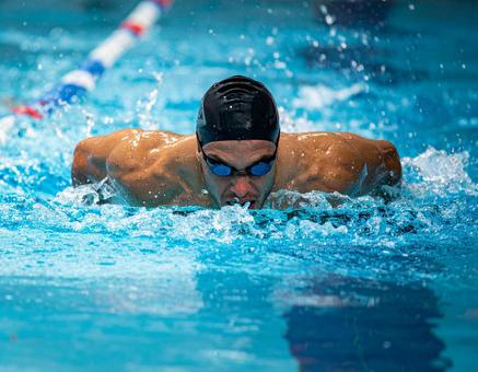 Swimmer swimming powerfully in the butterfly stroke, swimming, swimming, swimmer, JPG