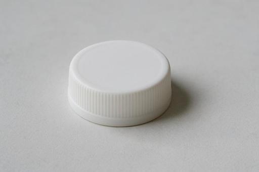 白いペットボトルの蓋 白いペットボトルの蓋の写真