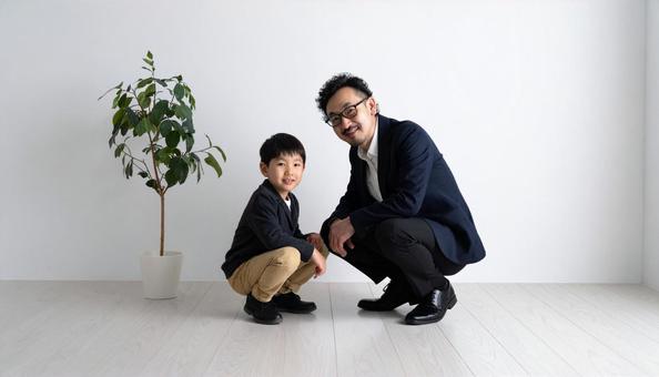 しゃがむ親子 父子 サプライズ計画中 しゃがむ親子 父子 サプライズ計画中 の写真
