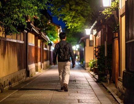 静かな住宅街を歩く男性の後ろ姿 静かな住宅街を歩く男性の後ろ姿の写真
