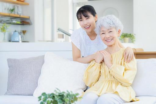 リビングでくつろぐ孫と祖母 リビングでくつろぐ孫と祖母 家族,シニア,女性の写真素材