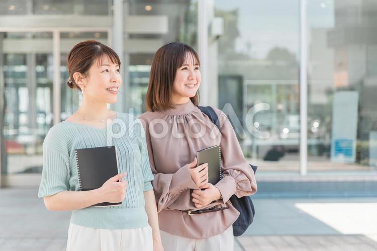 ノートを持って歩くアジア人女性 ビジネスウーマン,ol,ビジネスの写真素材
