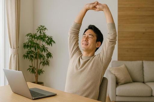 在宅勤務中、姿勢を正す男性 在宅勤務中、姿勢を正す男性の写真