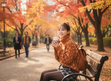 秋の公園でホットココアを飲む女性 秋の公園でホットココアを飲む女性の写真