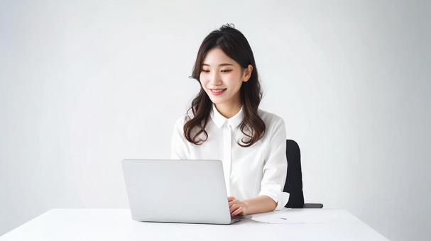 パソコンを使って仕事する若い女性 パソコンを使って仕事する若い女性の写真