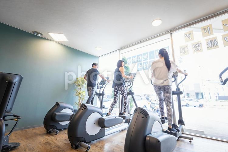 スポーツジムで運動する男女（笑顔） スポーツジム,有酸素運動,運動の写真素材