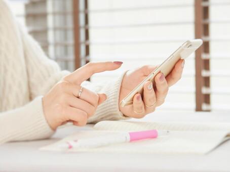 Image of a woman touching a smartphone Image of a woman touching a smartphone