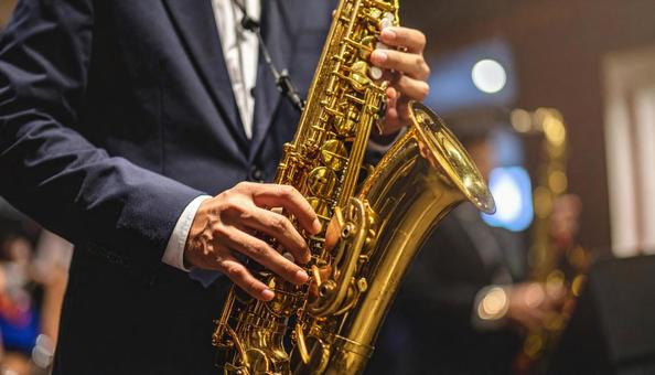 バリトンサックスを演奏する男性 バリトンサックスを演奏する男性の写真