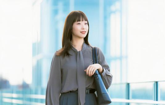 A woman/businesswoman walking in an office district, JPG A woman/businesswoman walking in an office district, JPG