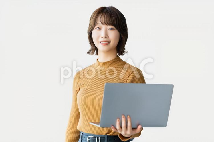 ノートパソコンを持つ笑顔の女性 パソコン,女性,笑顔の写真素材