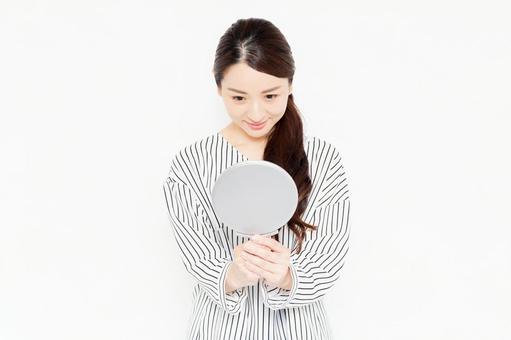 Casually dressed female holding a hand mirror, hand mirror, female, to see, JPG