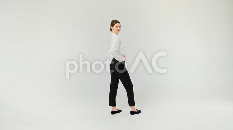 腰に手を当て振り向きカメラ目線の女性 女性,振り向く,腰に手の写真素材